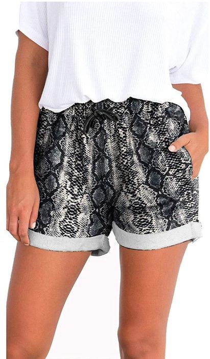 The model is wearing snakeskin-print drawstring shorts with a ribbed tee.