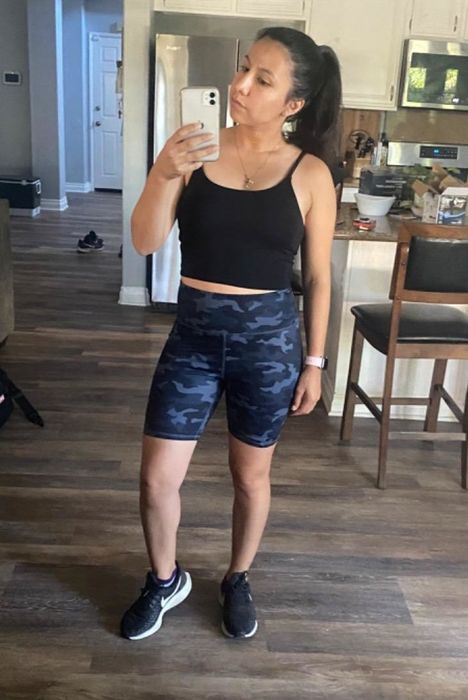 The reviewer is wearing blue biker shorts.