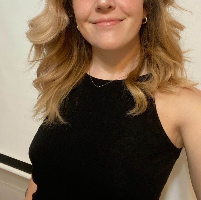 A close-up shot of a reviewer wearing the black version, highlighting the halter neck design.
