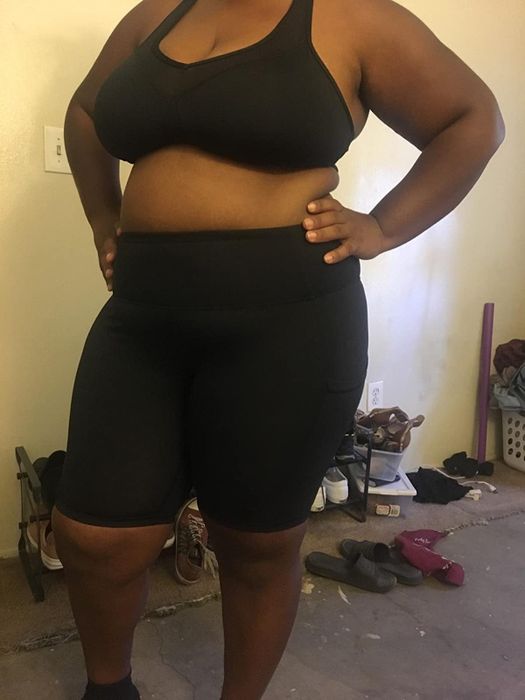 Plus-size reviewer confidently wearing the black compression bike shorts.