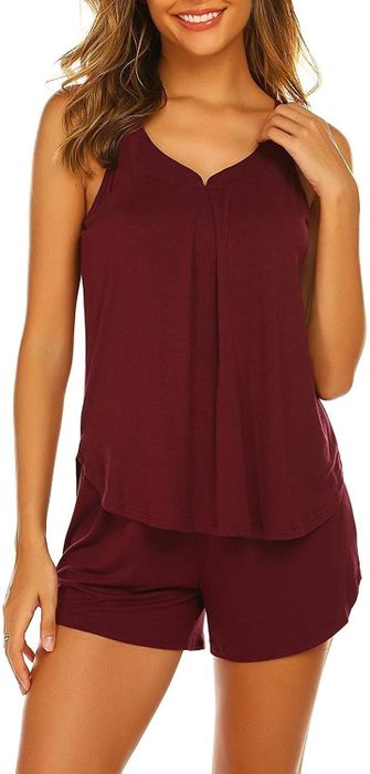 The model is seen in a bold red set, radiating style and confidence.