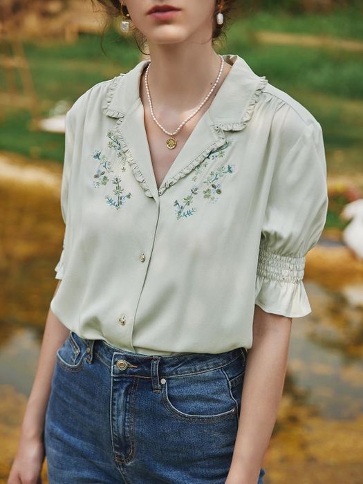 The blouse in a soft light green shade.