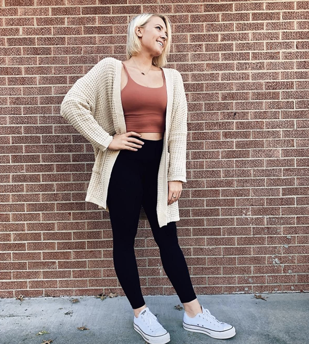 A reviewer is seen wearing the cream-colored cardigan.