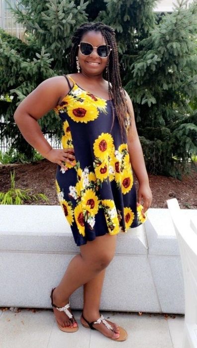 Reviewer in the black and yellow sunflower spaghetti strap dress, size large