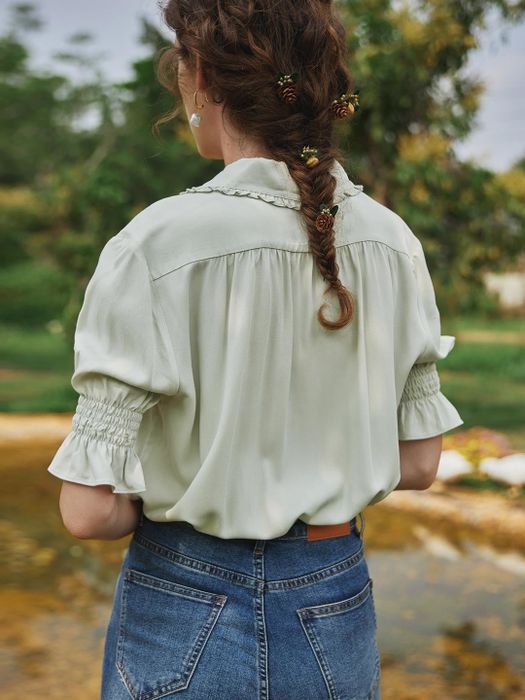 The back of the blouse showcasing the ruffled sleeves.