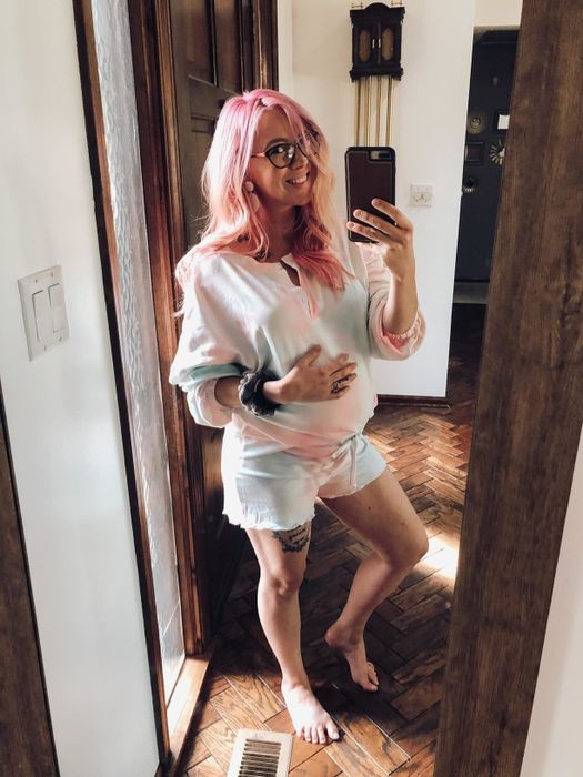 A reviewer dons a long-sleeve shirt paired with matching shorts in a pastel cotton candy tie-dye design.