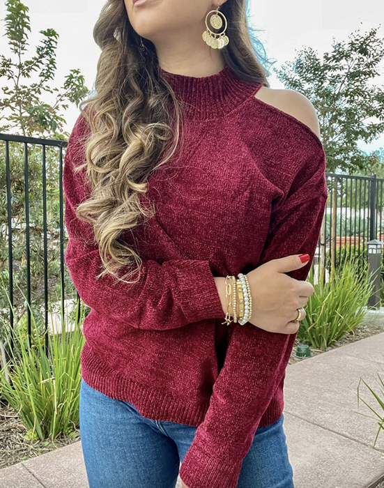 A reviewer is showcasing the cutout sweater.