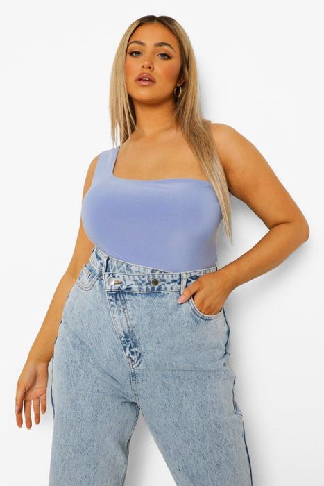 Model wearing the bodysuit in blue, paired with jeans