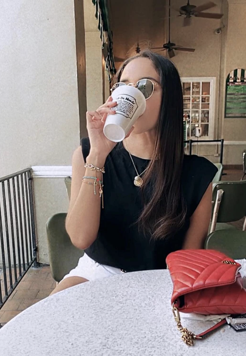 A customer is wearing the sleeveless top in black.