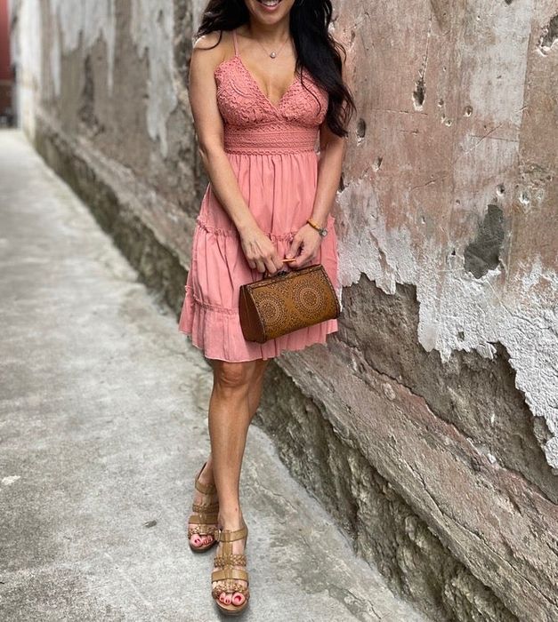 A reviewer flaunting the pink version of the dress.