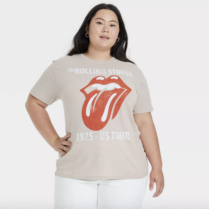 A model is wearing the beige Rolling Stones shirt.