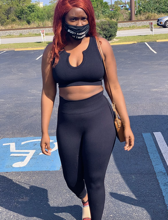 A reviewer is wearing the black activewear set.