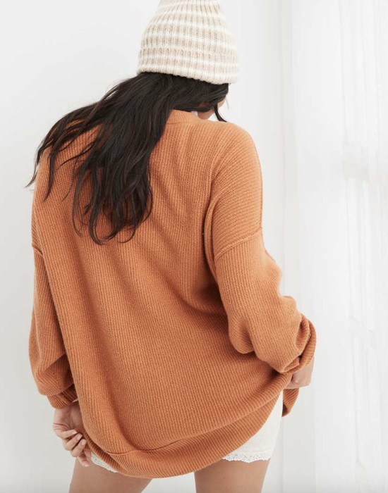 Model showing the back of the ribbed sweater
