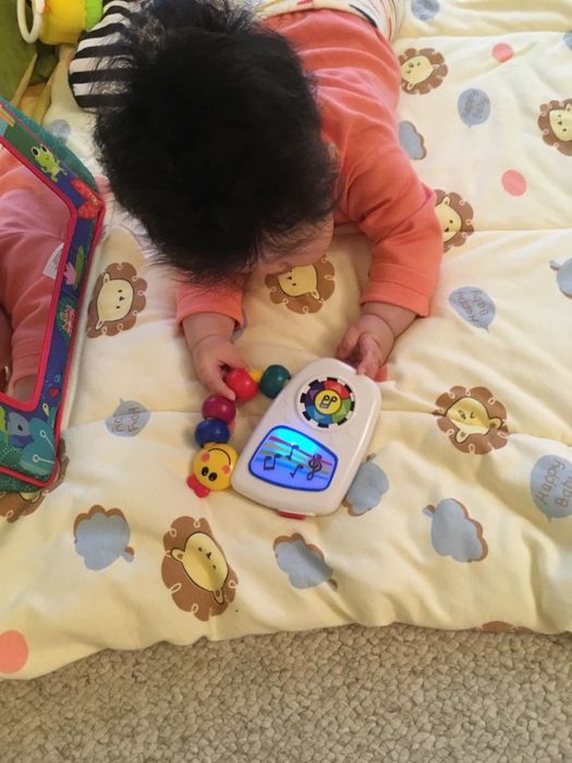 A reviewer's photo showing their baby holding the toy