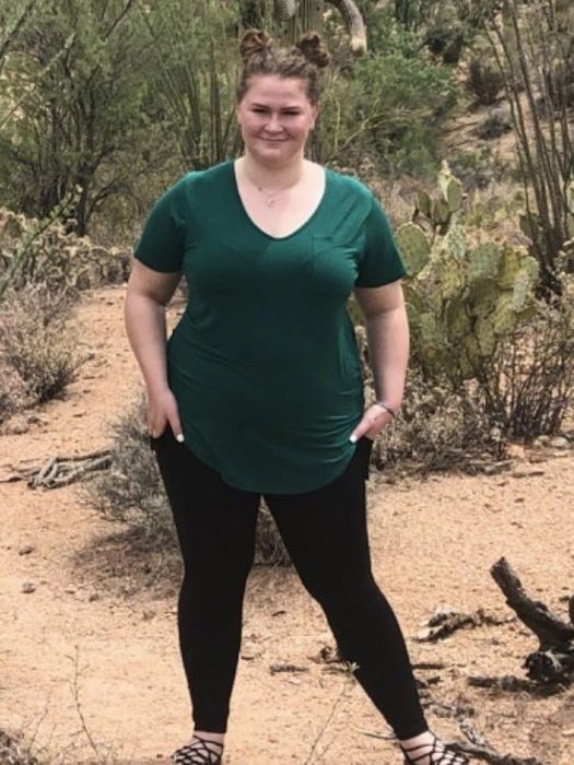 A reviewer wearing the scoop collar T-shirt in green.