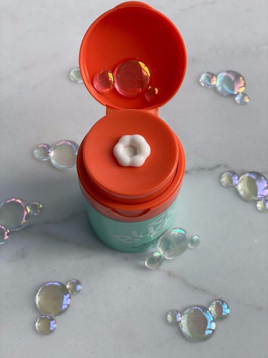a flower-shaped lotion being dispensed from a container