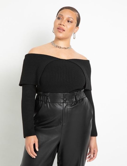 Model wearing a black off-the-shoulder sweater