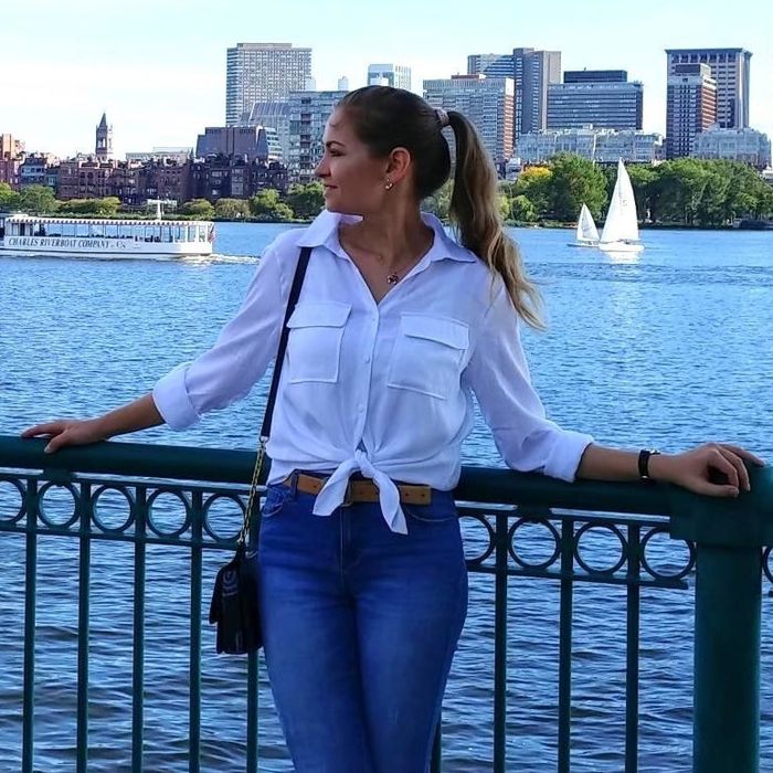 A reviewer styling the white shirt with a knot at the front.
