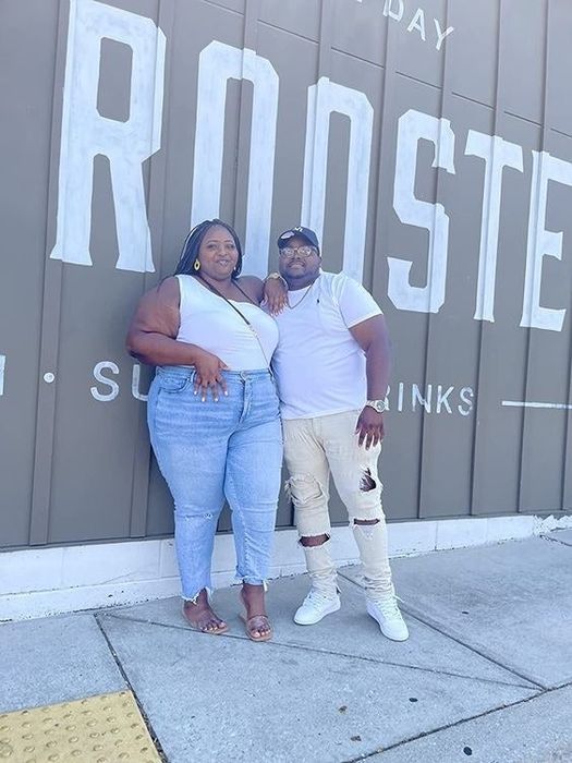 A reviewer showcasing the one-shoulder top in white.
