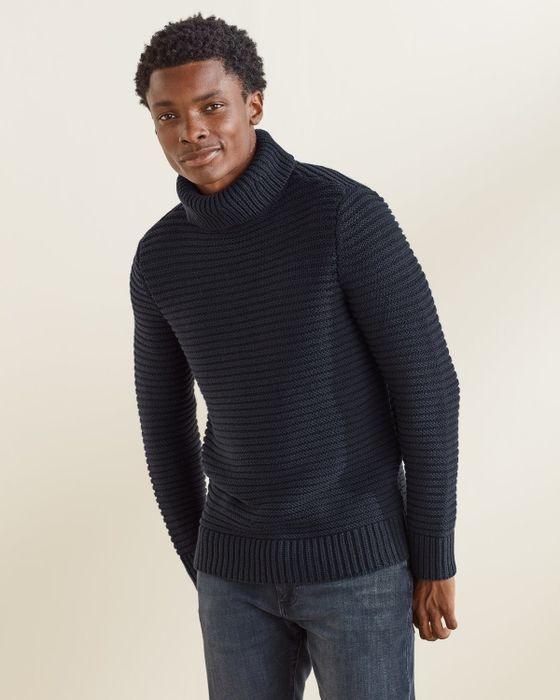 A model wearing a navy sweater.