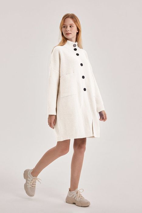 Model styling a white sweater