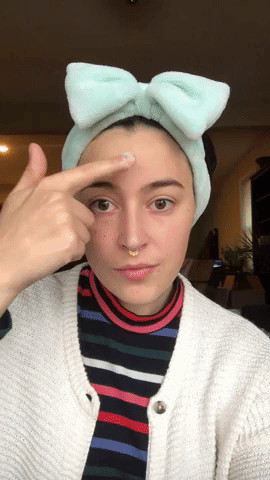 gif of a Mytour editor applying the lotion to their face