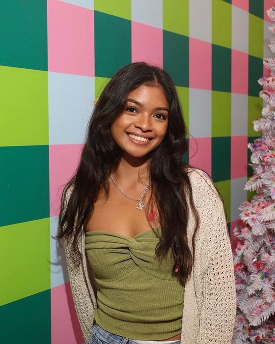 A reviewer is seen wearing the avocado-colored top.