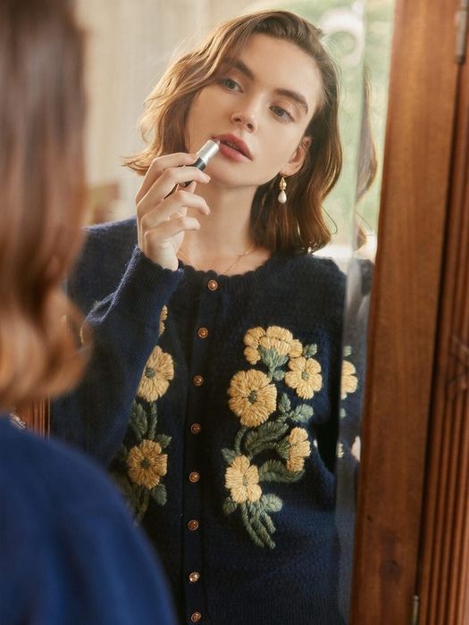 A model wearing a floral embroidered sweater