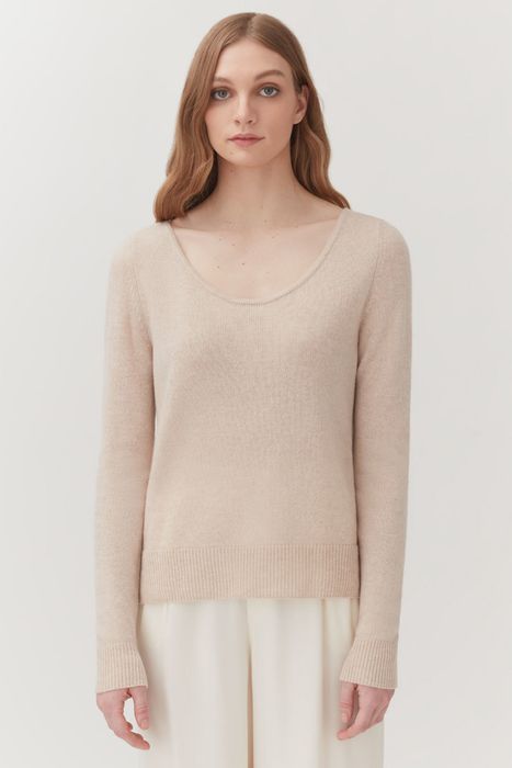 A model dressed in a sweater in core color.