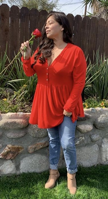 A different reviewer wearing the top in red with jeans.