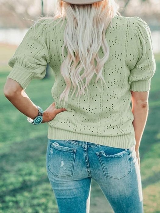 Back view of the same model wearing the top in green