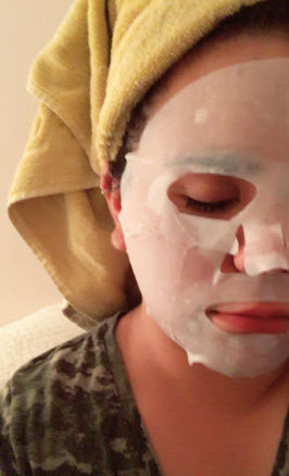 a reviewer wearing a white sheet mask