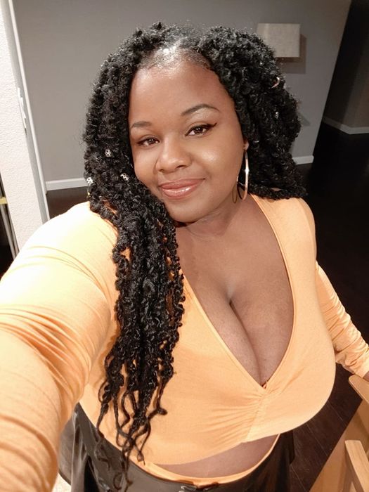 A reviewer showcasing the mustard yellow top.