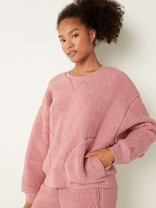 Model rocking a pink sweatshirt, looking effortlessly stylish.