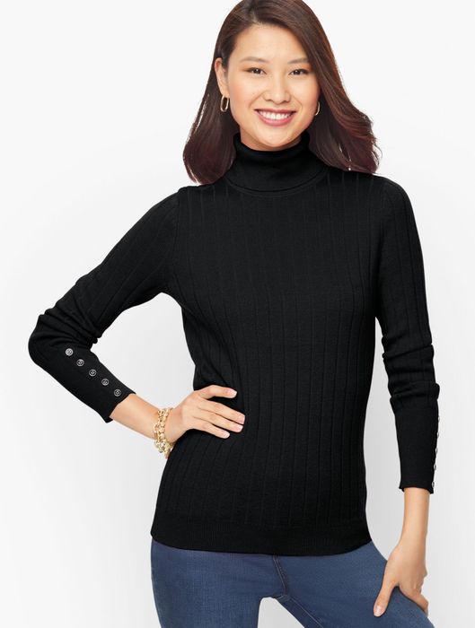 A model showcasing a black sweater.
