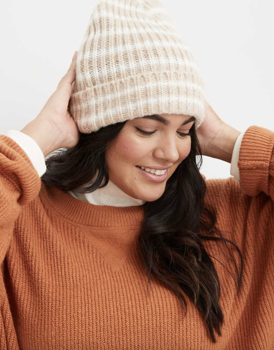 Model wearing a beanie with the sweater