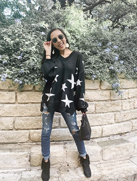 A person dressed in a black star-patterned sweater.