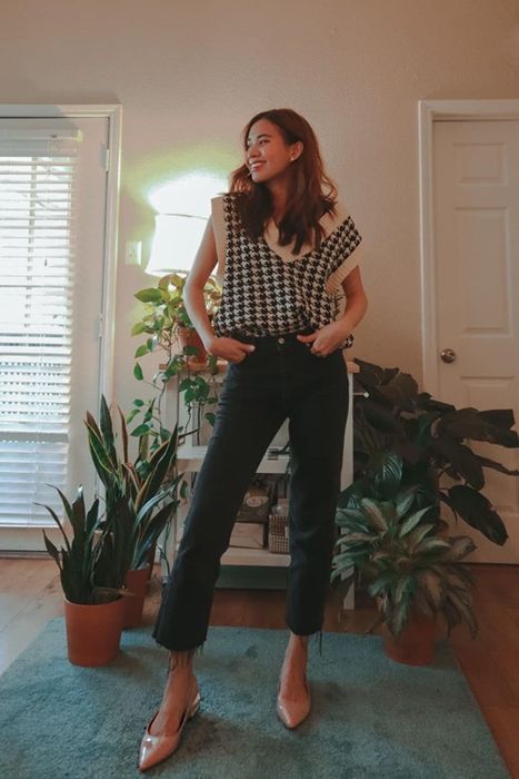 Reviewer styling the sweater vest, showing off a chic and comfy look.