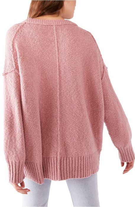 Model wearing a pink sweater