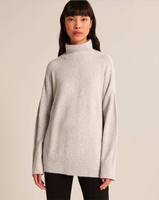 A model showcasing a gray sweater.