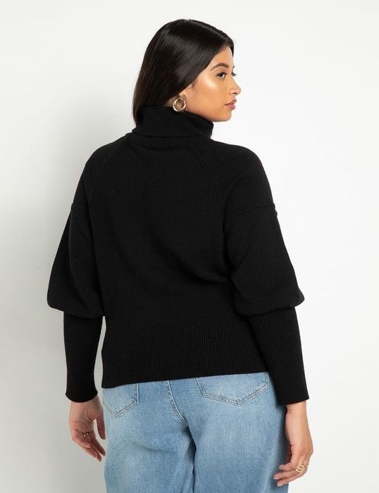 Model displaying a black sweater from the back