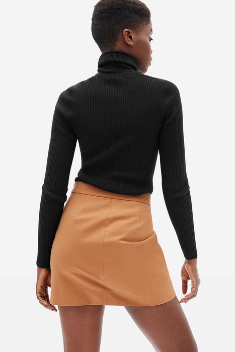 Model wearing a black sweater, showing the back view