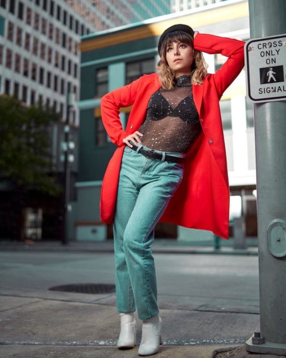 A reviewer showing off the black mesh top with silver sparkles.