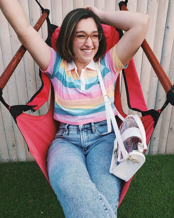 A reviewer is sporting a colorful, multi-hued top.