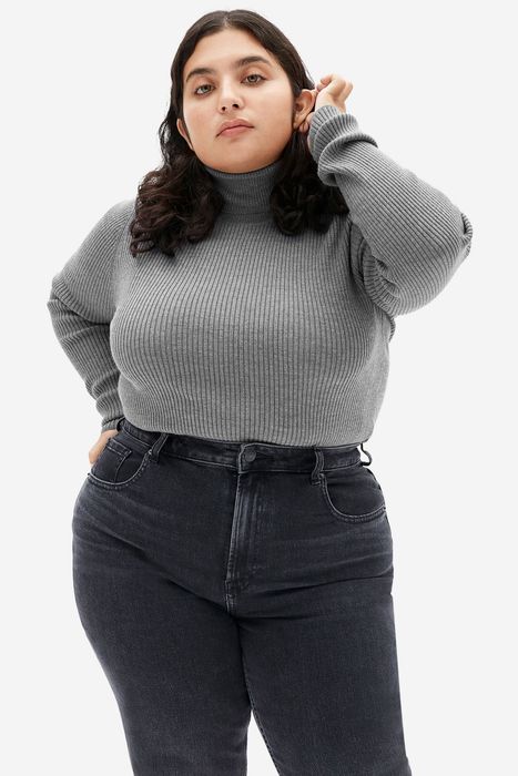 Model wearing a gray sweater, front view