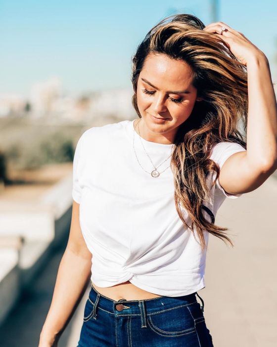 A reviewer wearing the crisscross T-shirt in white.
