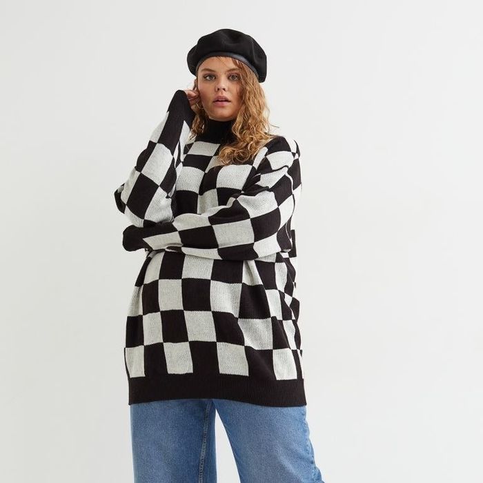 Model wearing a checkered sweater