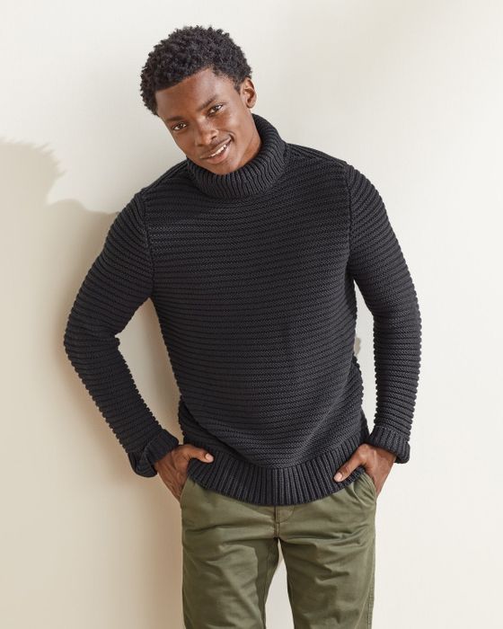 A model wearing a black sweater.