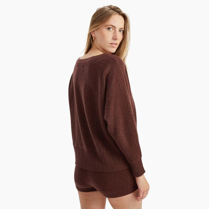Model displaying the brown sweater from the back
