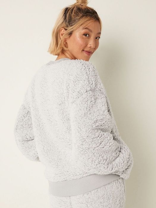 Model in a crisp white sweatshirt, bringing the perfect balance of simplicity and chic style.